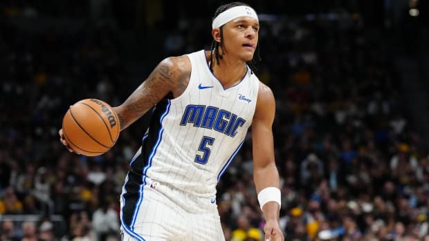 Magic forward dribbles the ball in a game.